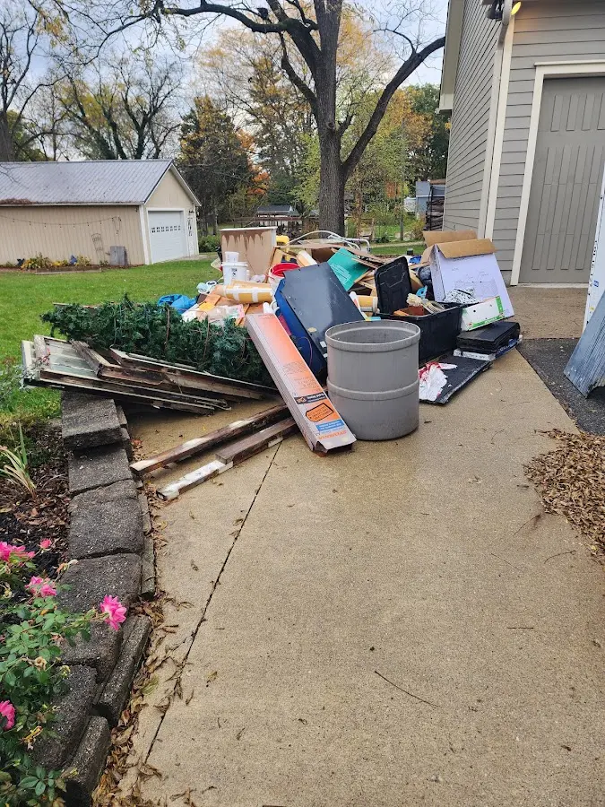 Dumpster being loaded with debris for Commercial Dumpster Rental in Charlestown